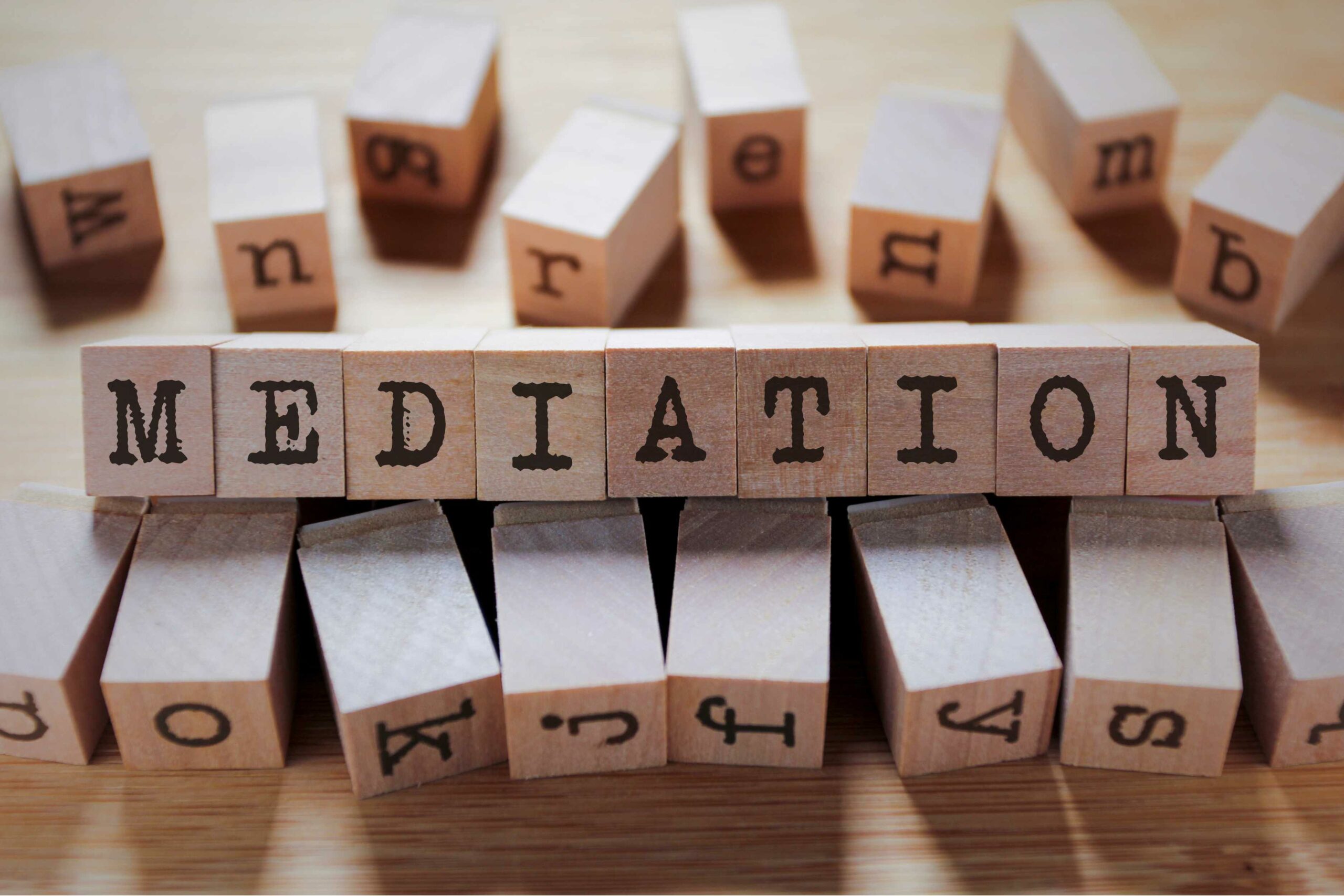 This image shows wooden blocks with black font lined together to spell the word 'Mediation'. Family Dispute Resolution is a type of mediation.